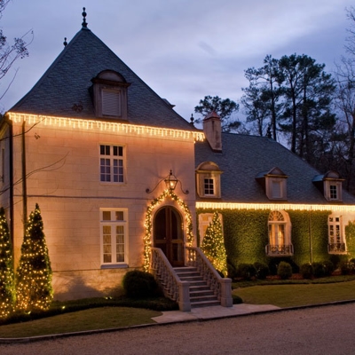 Full-service holiday lighting in Cincinnati with roofline, tree wraps and garland make this home per Photo